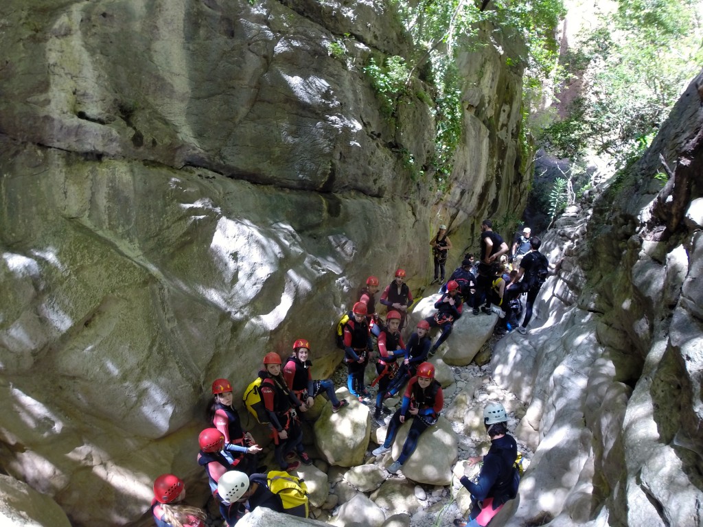 Suited up and ready to go, our group awaits its first rappel while canyoning in Grazalema's Garganta Verde.